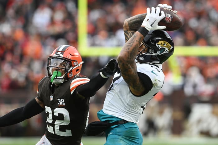 Dec 10, 2023; Cleveland, Ohio, USA; Jacksonville Jaguars tight end Evan Engram (17) catches a pass as Cleveland Browns safety Grant Delpit (22) defends during the first half at Cleveland Browns Stadium.